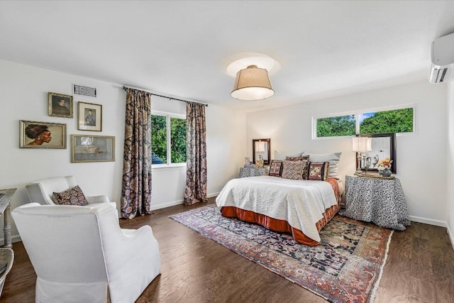 6201 Sun Vista Dr, Austin, TX 78749 - bedroom with a wall mounted air conditioner, baseboards, and wood finished floors
