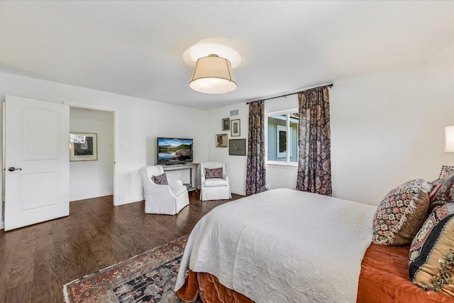 bedroom featuring wood finished floors and baseboards