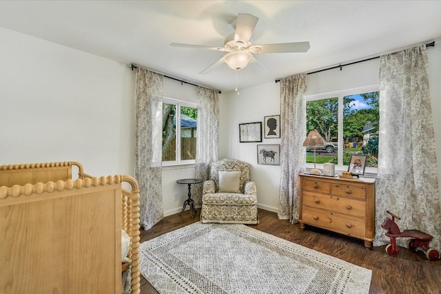 sitting room with ceiling fan, wood finished floors, and baseboards