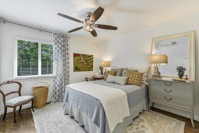 bedroom with light wood-style flooring, baseboards, and ceiling fan