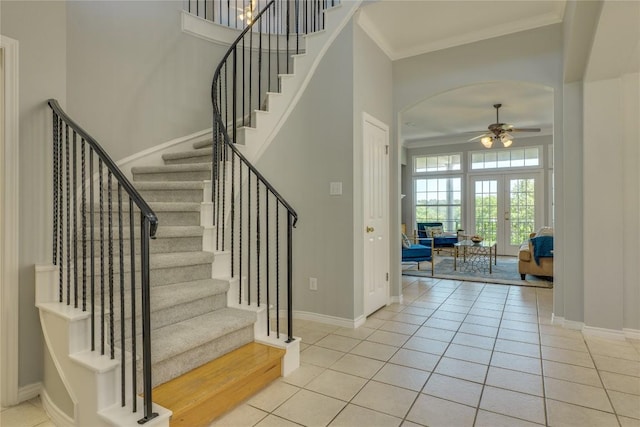5133 Valburn Ct, Austin, TX 78731 - tiled foyer entrance featuring a ceiling fan, stairway, arched walkways, ornamental molding, and french doors