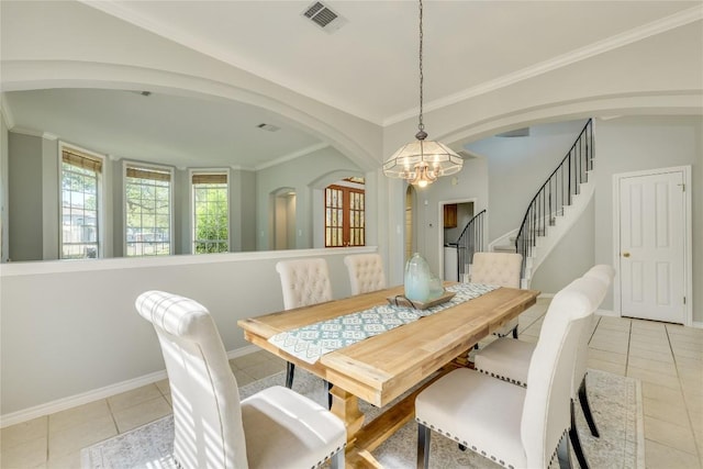 5133 Valburn Ct, Austin, TX 78731 - dining space featuring arched walkways, light tile patterned floors, a chandelier, stairs, and crown molding