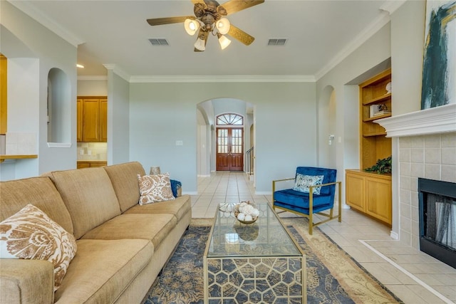 5133 Valburn Ct, Austin, TX 78731 - living area featuring arched walkways, light tile patterned flooring, crown molding, a fireplace, and a ceiling fan
