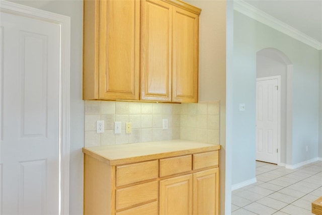 5133 Valburn Ct, Austin, TX 78731 - kitchen featuring arched walkways, crown molding, light tile patterned flooring, light brown cabinets, and backsplash