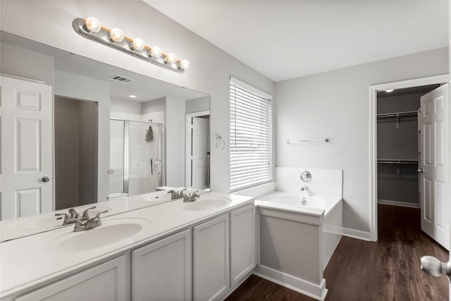1600 Gretchen Dr, Cedar Park, TX 78613 - full bath featuring a shower stall, wood finished floors, a bath, double vanity, and a walk in closet