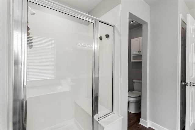 1600 Gretchen Dr, Cedar Park, TX 78613 - bathroom with toilet, a shower stall, wood finished floors, and baseboards