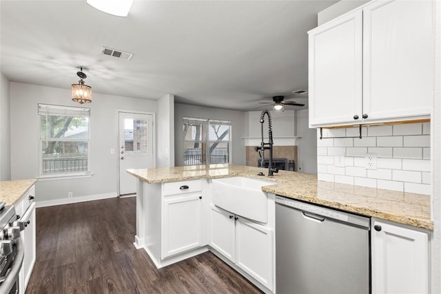 1600 Gretchen Dr, Cedar Park, TX 78613 - kitchen with stainless steel dishwasher, a peninsula, tasteful backsplash, dark wood finished floors, and range