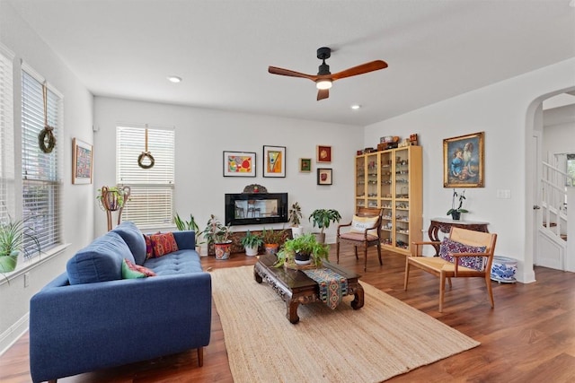 7609 Lazy Creek Dr, Austin, TX 78724 - living area with arched walkways, wood finished floors, ceiling fan, and recessed lighting