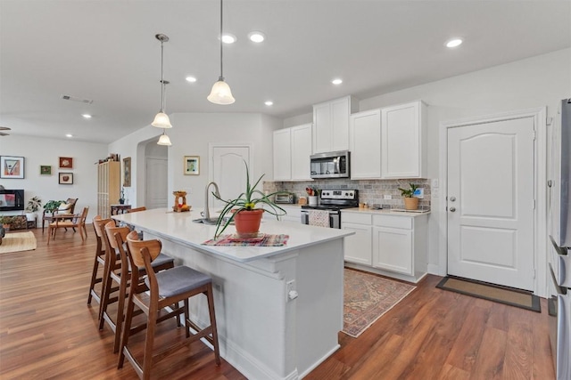 7609 Lazy Creek Dr, Austin, TX 78724 - kitchen with stainless steel appliances, decorative backsplash, dark wood-type flooring, light countertops, and white cabinetry