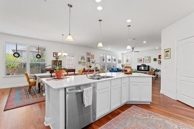 7609 Lazy Creek Dr, Austin, TX 78724 - kitchen featuring dishwasher, open floor plan, wood finished floors, light countertops, and recessed lighting