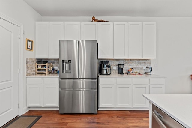 7609 Lazy Creek Dr, Austin, TX 78724 - kitchen featuring appliances with stainless steel finishes, light countertops, decorative backsplash, and white cabinetry
