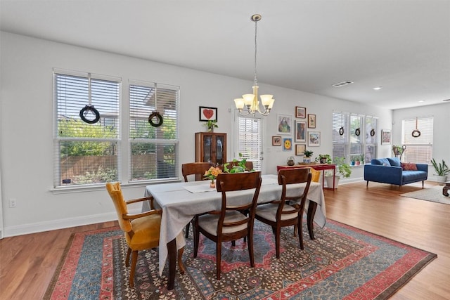 7609 Lazy Creek Dr, Austin, TX 78724 - dining room featuring wood finished floors and a chandelier