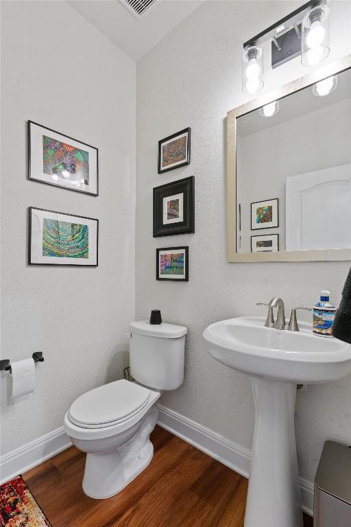 7609 Lazy Creek Dr, Austin, TX 78724 - bathroom featuring baseboards and wood finished floors