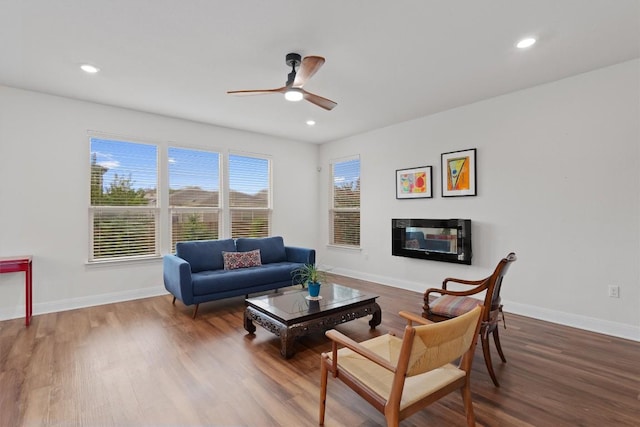 7609 Lazy Creek Dr, Austin, TX 78724 - living area featuring a ceiling fan, wood finished floors, recessed lighting, and a glass covered fireplace