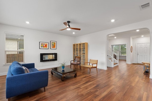 7609 Lazy Creek Dr, Austin, TX 78724 - living room with arched walkways, wood finished floors, stairs, ceiling fan, and recessed lighting