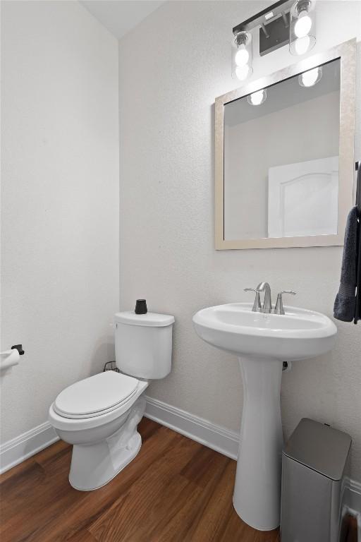 7609 Lazy Creek Dr, Austin, TX 78724 - bathroom featuring wood finished floors and toilet