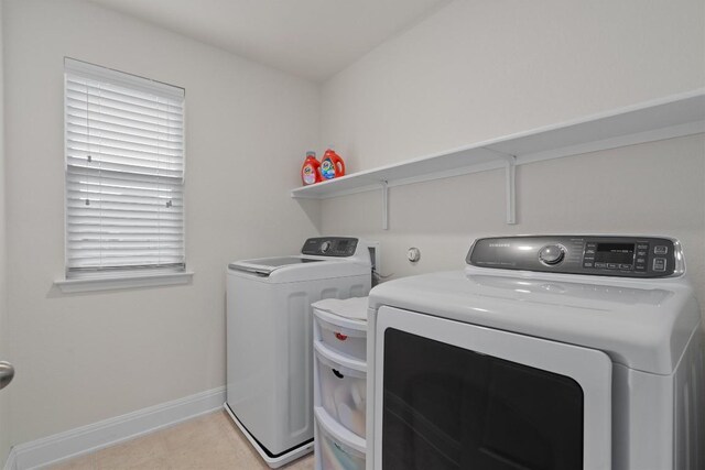 7609 Lazy Creek Dr, Austin, TX 78724 - laundry room featuring washer and clothes dryer and light tile patterned floors