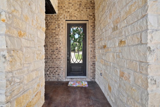 property entrance with stone siding