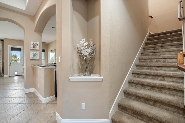 937 Wild Rose Dr, Austin, TX 78737 - stairway with arched walkways, tile patterned floors, and baseboards