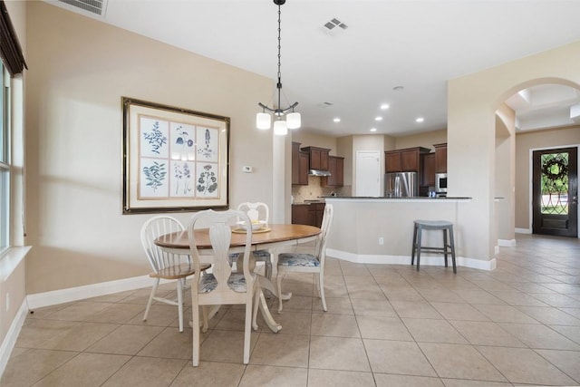 937 Wild Rose Dr, Austin, TX 78737 - dining room featuring light tile patterned floors, arched walkways, baseboards, and recessed lighting