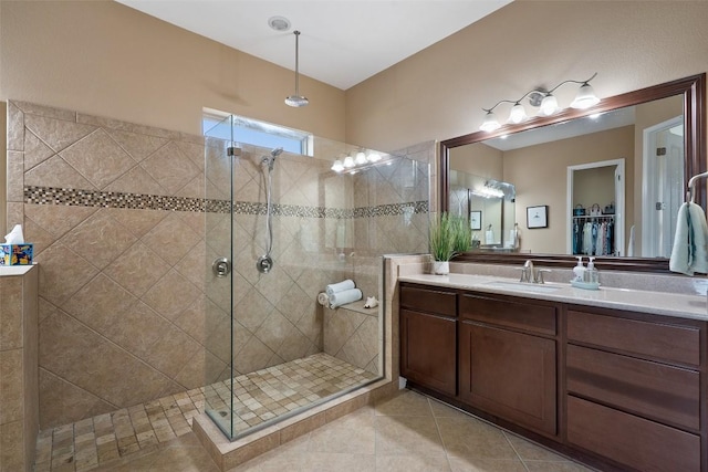 full bath featuring a stall shower, vanity, and tile patterned floors