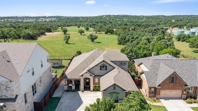 aerial view of property and surrounding area featuring a heavily wooded area