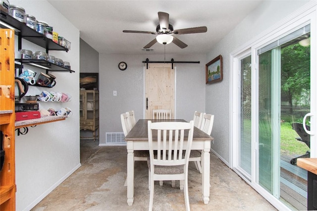 12 Catalpa Ct, Belton, TX 76513 - dining space featuring a barn door, concrete floors, ceiling fan, and baseboards
