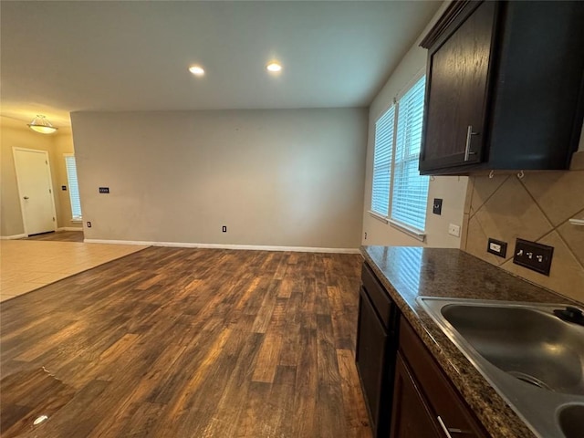253 Eagle Brook Ln, Buda, TX 78610 - kitchen featuring dark countertops, dark wood finished floors, open floor plan, tasteful backsplash, and recessed lighting