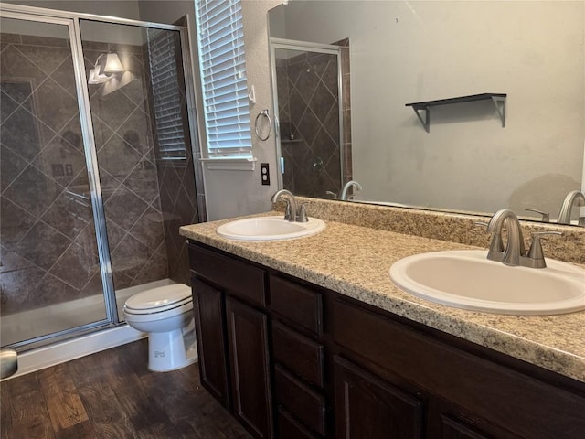 253 Eagle Brook Ln, Buda, TX 78610 - full bath with double vanity, a shower stall, and wood finished floors