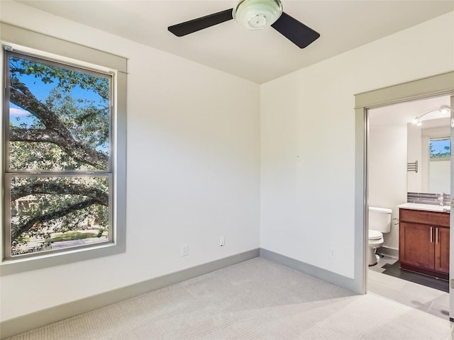 614 Terrell Hill Dr Unit B, Austin, TX 78704 - unfurnished bedroom with light colored carpet, connected bathroom, and a ceiling fan