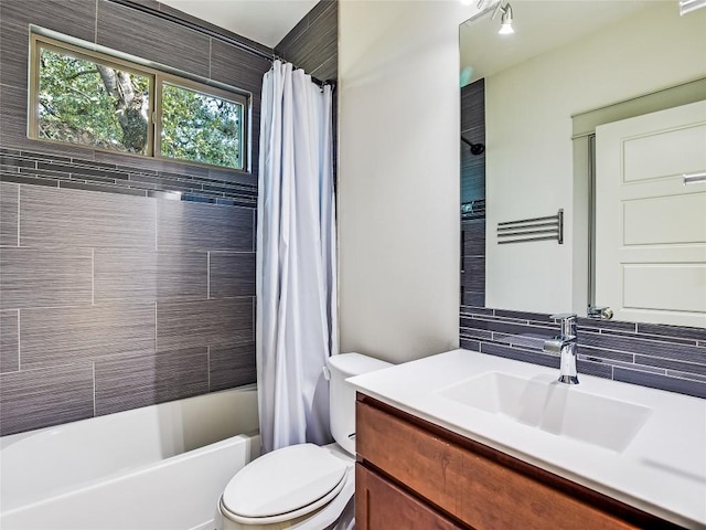 full bathroom with tasteful backsplash, toilet, shower / bath combo with shower curtain, and vanity