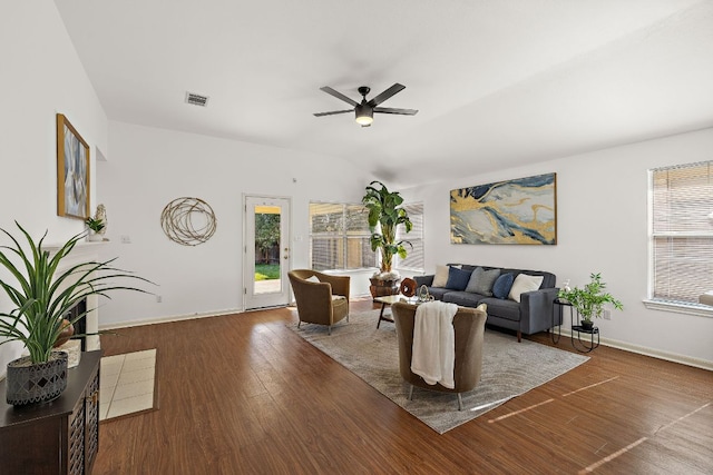 living room with ceiling fan, baseboards, wood finished floors, and vaulted ceiling