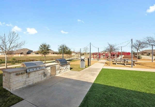 view of home's community with exterior kitchen and a yard