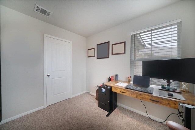 office space with light carpet and baseboards