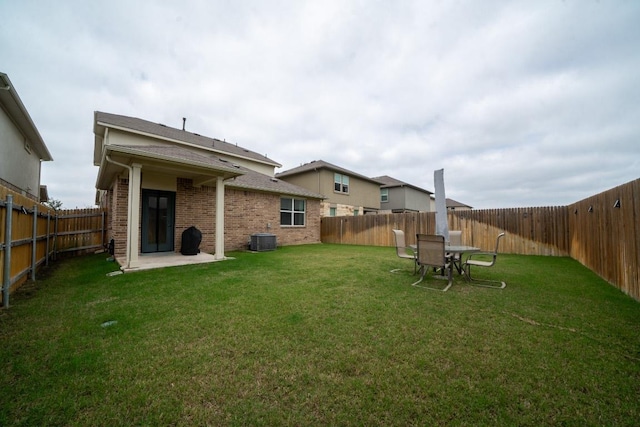 rear view of property featuring central air condition unit, brick siding, and a patio area