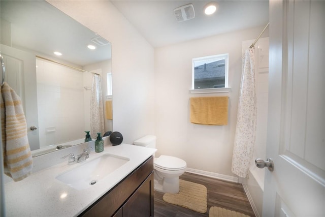 bathroom with wood finished floors, toilet, baseboards, vanity, and recessed lighting