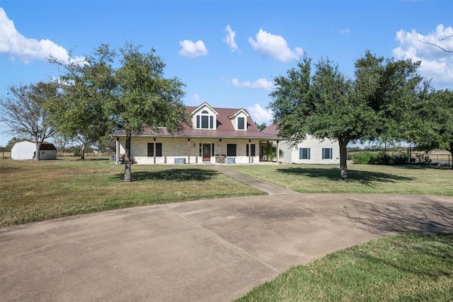 155 Gabriel Farms Dr, Hutto, TX 78634 - cape cod house featuring a front yard and stone siding