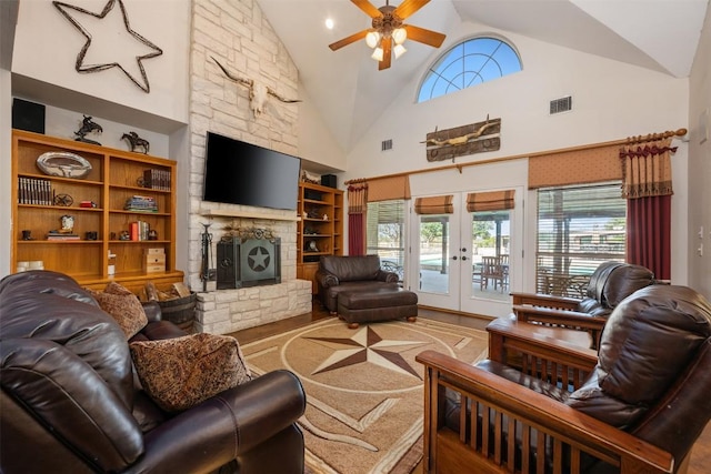 155 Gabriel Farms Dr, Hutto, TX 78634 - living room with wood finished floors, ceiling fan, french doors, a fireplace, and healthy amount of natural light
