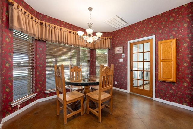 155 Gabriel Farms Dr, Hutto, TX 78634 - dining area featuring baseboards, a chandelier, wallpapered walls, and washing machine and dryer