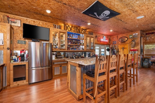 155 Gabriel Farms Dr, Hutto, TX 78634 - indoor wet bar with freestanding refrigerator, light wood-style flooring, fridge, and recessed lighting