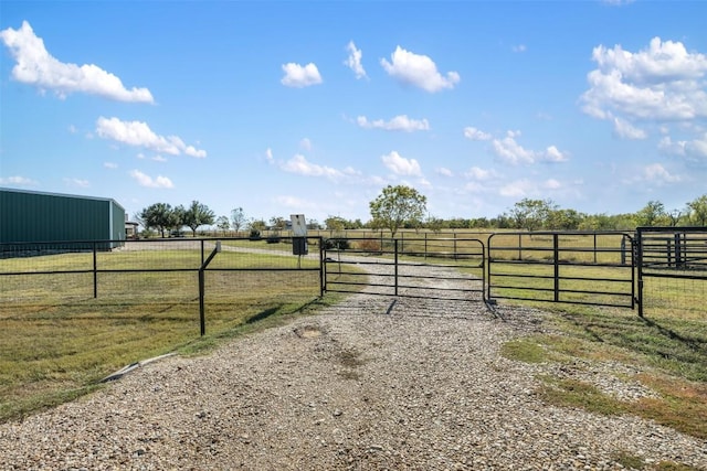 155 Gabriel Farms Dr, Hutto, TX 78634 - view of dirt / gravel driveway featuring a gate and a rural view