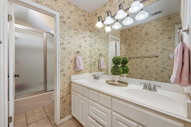 155 Gabriel Farms Dr, Hutto, TX 78634 - full bathroom with tile patterned flooring, double vanity, shower / bath combination with glass door, wallpapered walls, and baseboards