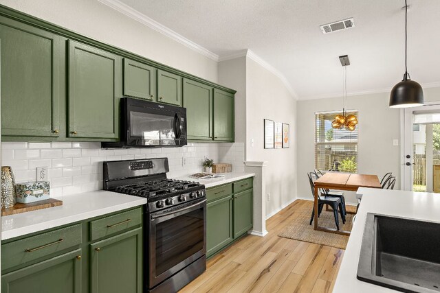 kitchen with stainless steel range with gas cooktop, green cabinetry, black microwave, decorative backsplash, and crown molding