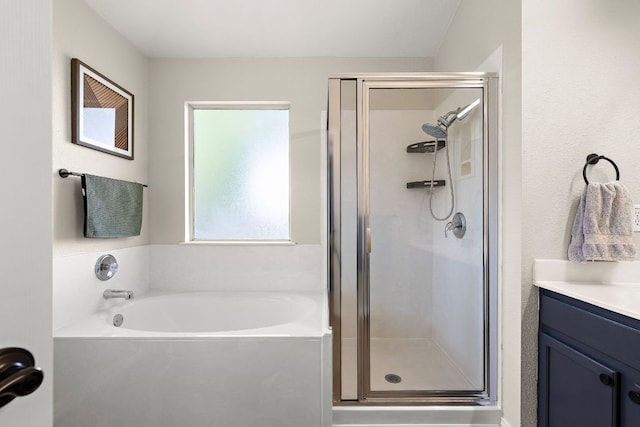 bathroom featuring a shower stall, a garden tub, and vanity