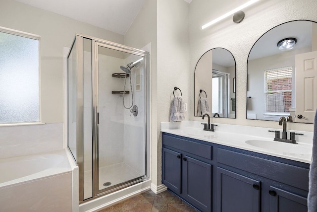 full bath with a stall shower, a garden tub, and double vanity