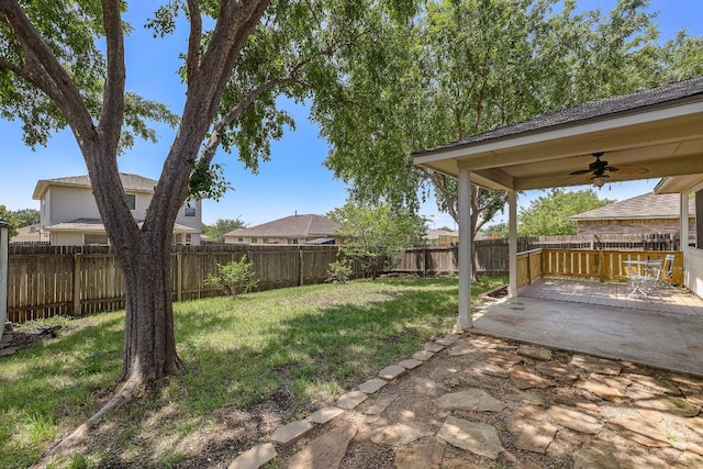 view of yard with ceiling fan and a patio area