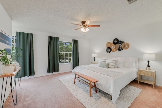 4702 White Elm Dr, Austin, TX 78749 - bedroom featuring light carpet, a textured ceiling, and a ceiling fan