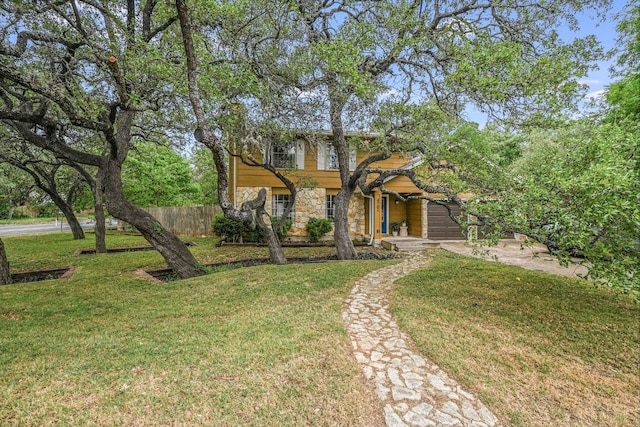 view of front of property with stone siding and a garage