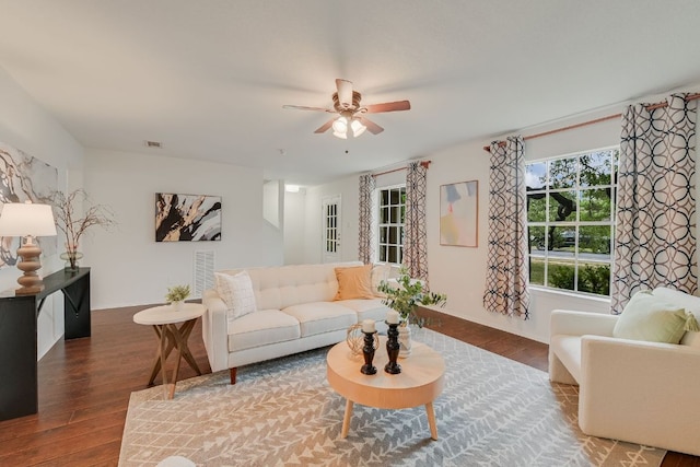 living room with wood finished floors, ceiling fan, and baseboards