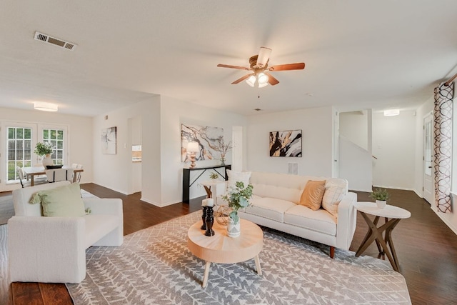 living area with wood finished floors, ceiling fan, and baseboards